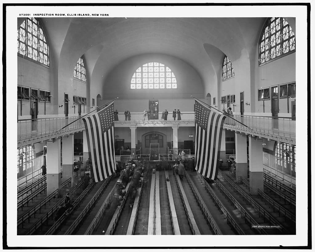 The Registry Room at Ellis Island, circa 1910 to 1920. Rows of benches fill the vast hall where immigrants waited to be inspected.