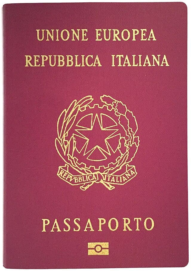 An Italian passport lying on a flat surface, open to the photo identification page.